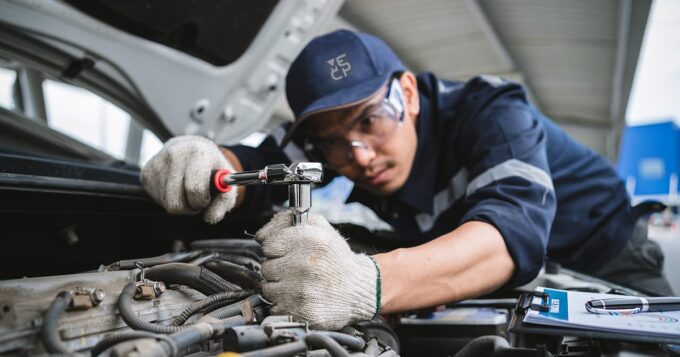 A mechanic fixing a car engine